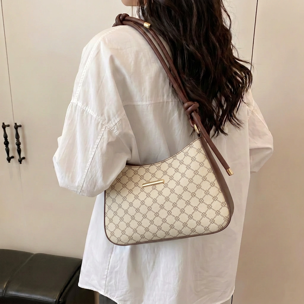 Model wearing BM15 Skin shoulder bag with cream patterned rexine, brown trim and gold hardware
